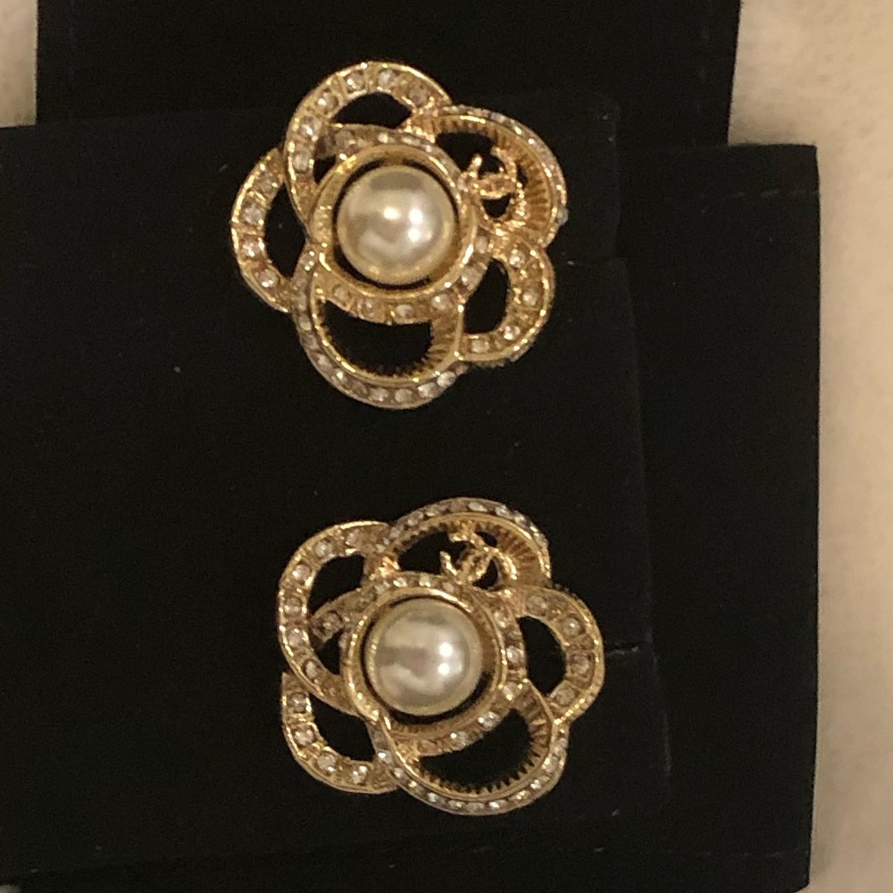 Chanel camellia pearl earrings.